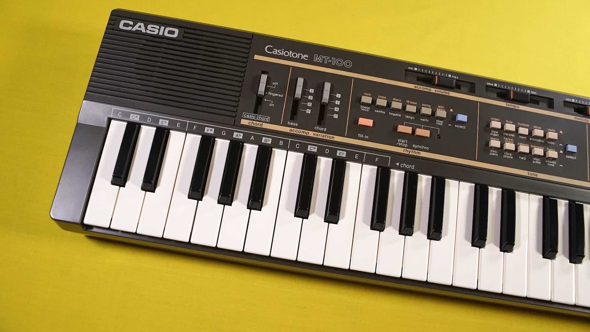 Casiotone MT-100 keyboard on a yellow background