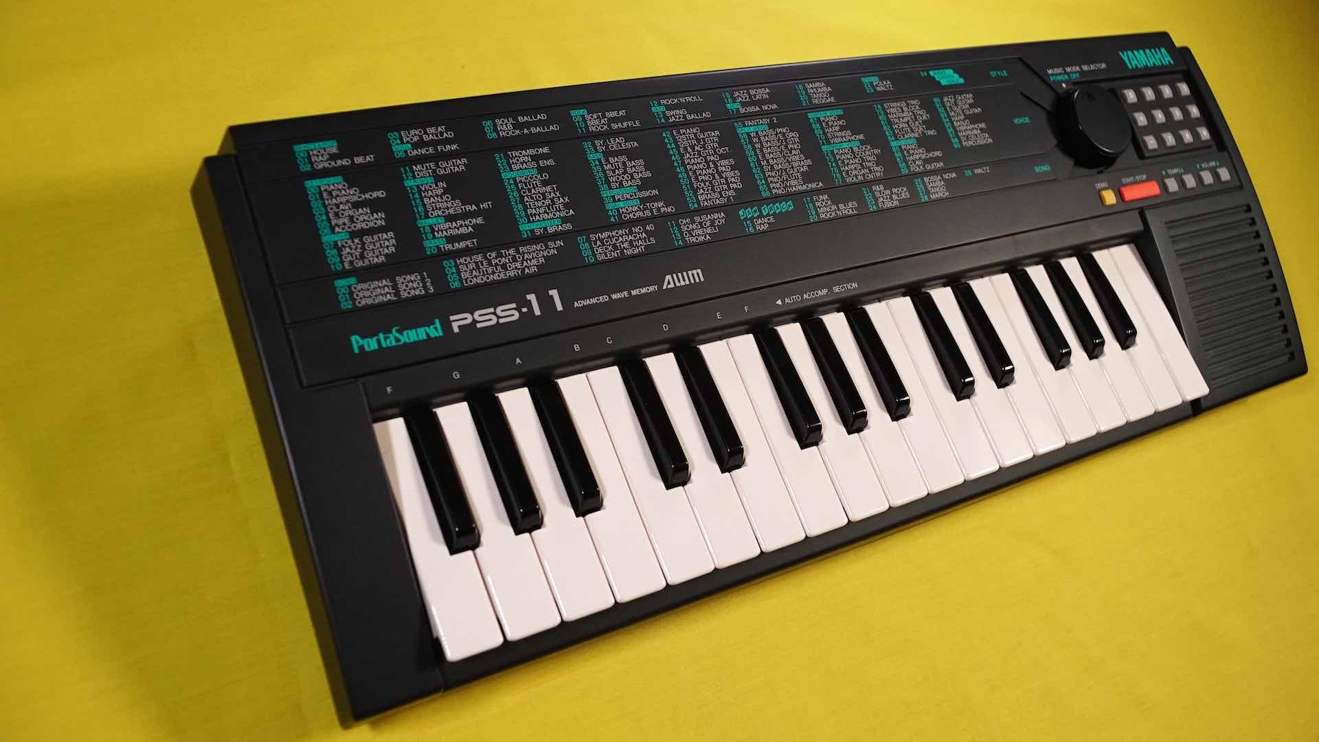 Yamaha PSS-11 keyboard against a yellow background